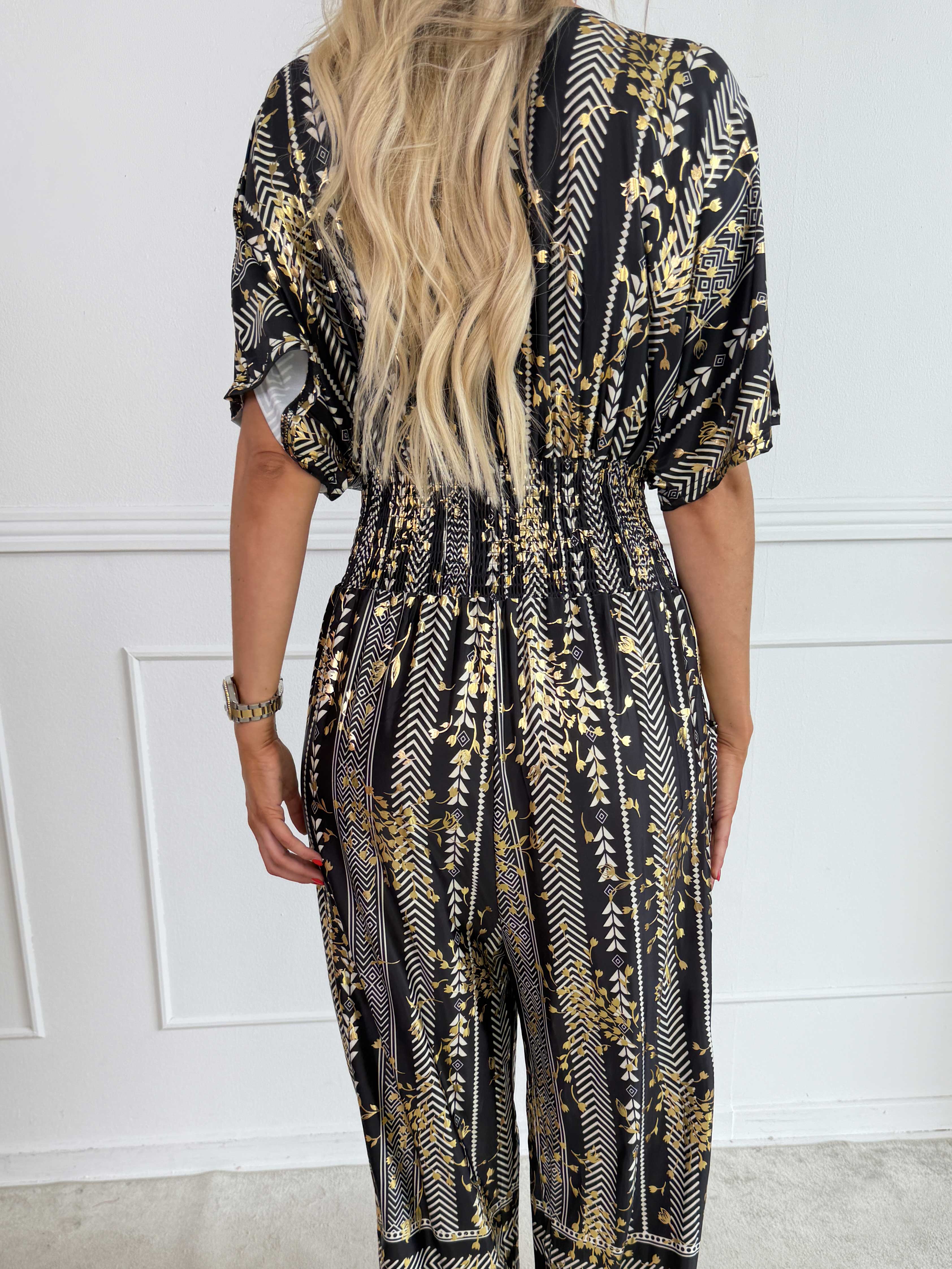 Pams Tribal Jumpsuit - Elastisk mønstret buksedragt med små guld blomster